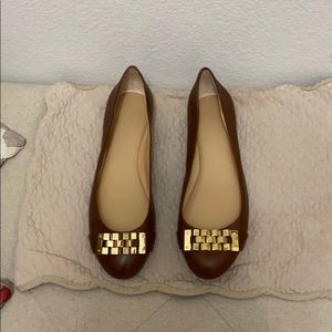 Brown leather flats.